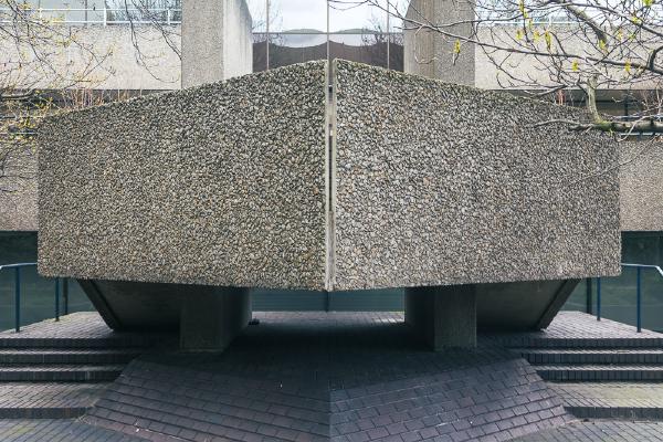 External staircase at the IBM building on London's South Bank contrasting texture and symmetry with the chaotic, natural growth of branches